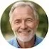 A circular profile headshot of David K., a smiling middle-aged man with gray hair and a short beard, wearing a blue shirt.